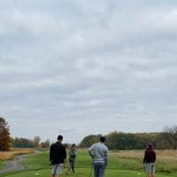 Five alumni playing golf
